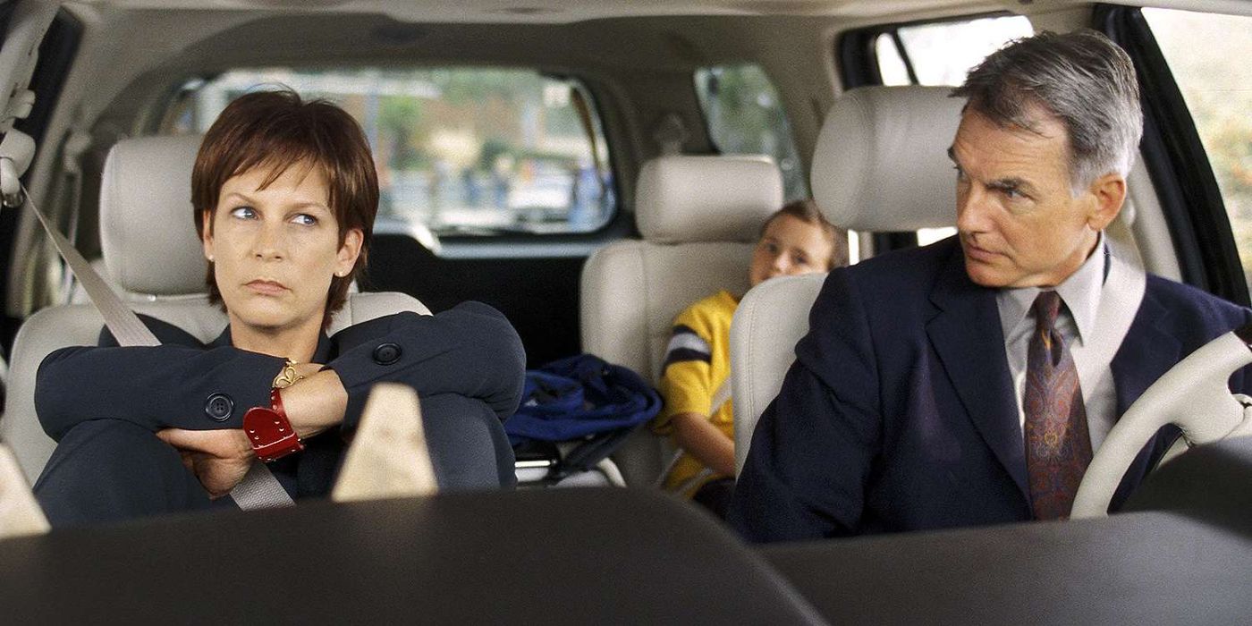 Jamie Lee Curtis as Tess and Mark Harmon as Ryan sitting in a car giving each other strange looks in Freaky Friday.