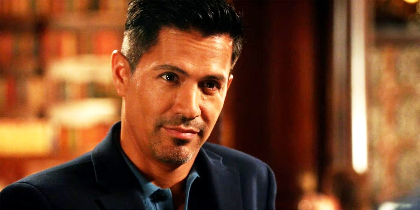 Jay Hernandez looking at someone while in a suit in Magnum PI