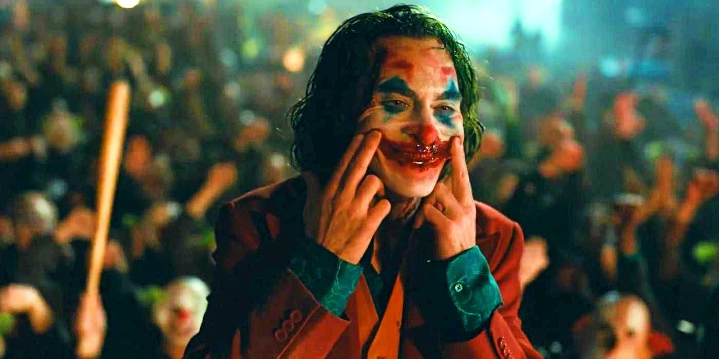 Joaquin Phoenix as Arthur Fleck smiles at the cheering mob in Joker