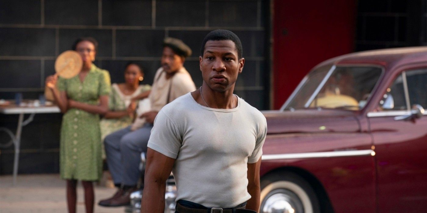 Jonathan Majors standing on the street in Lovecraft Country