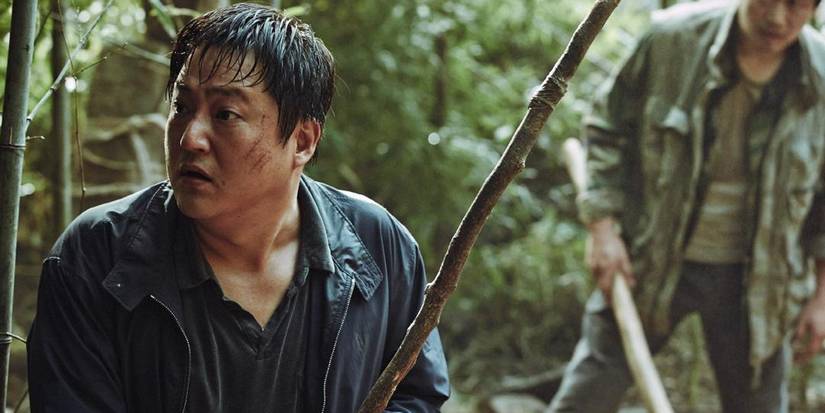 Jong-goo holding a stick in The Wailing.