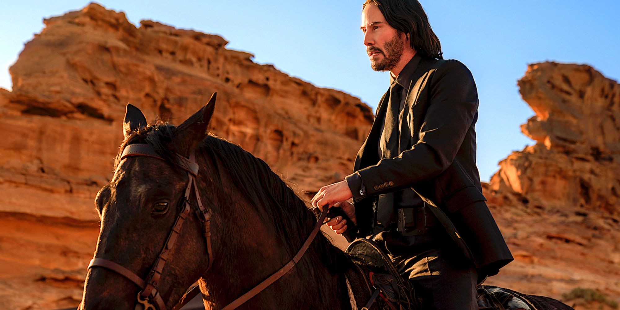 Keanu Reeves riding a horse in John Wick 4