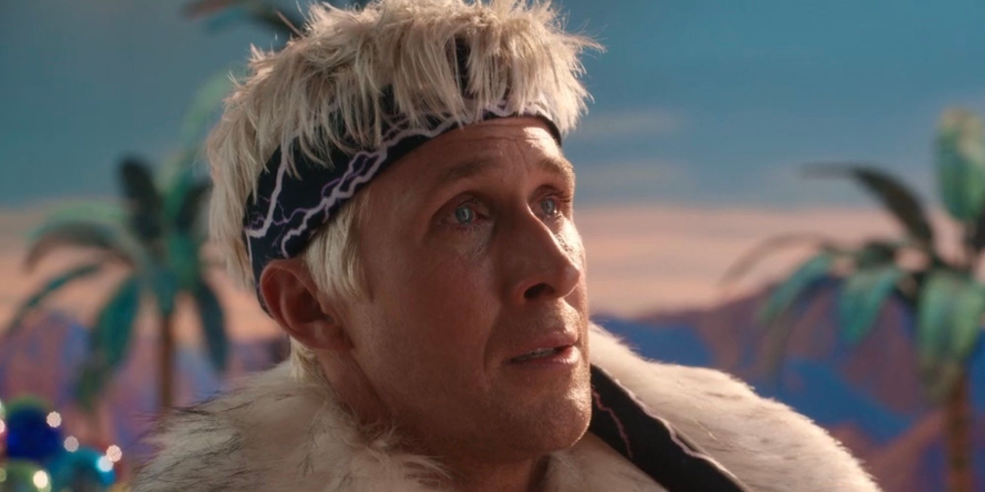 A teary-eyed Ken (Ryan Gosling) wearing a headband and fur coat looks devastated in Barbie.