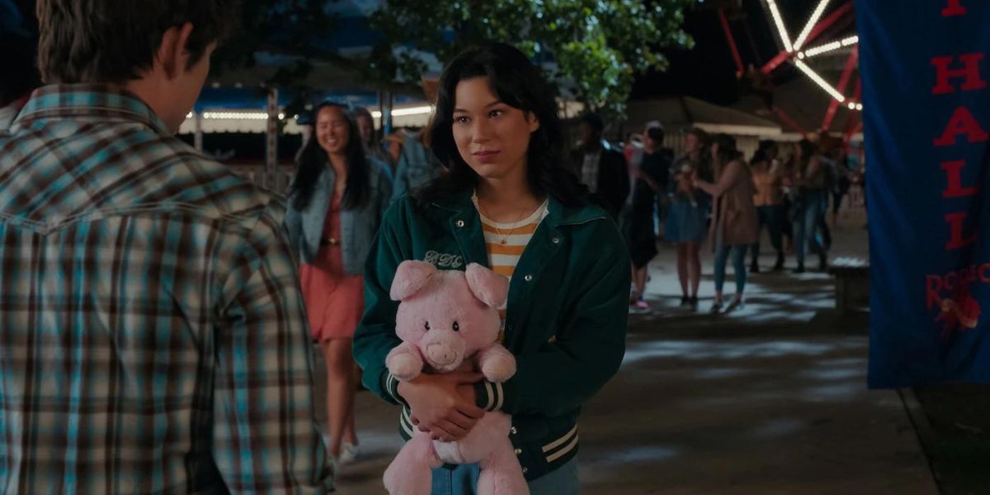 Mya Lowe's Kiley holding a stuffed animal while talking to Ashby Gentry's Alex in My Life with the Walter Boys at the fair