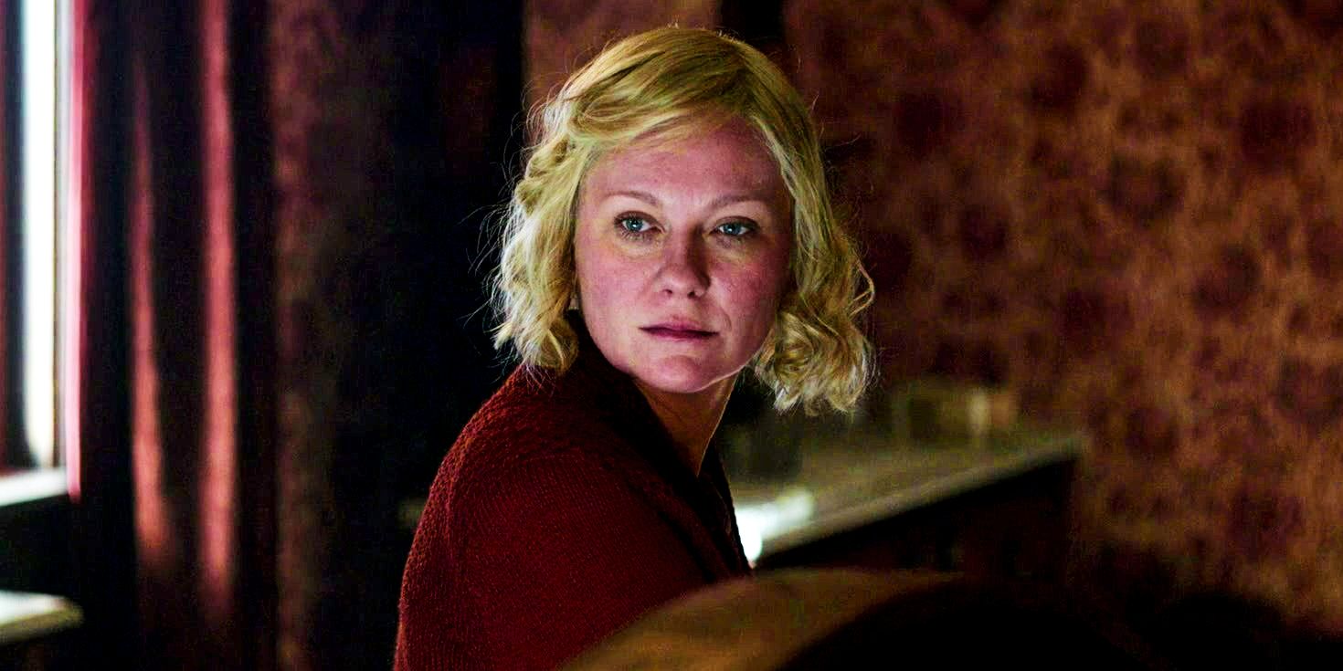 Kirsten Dunst as Rose Gordon sits in red room wearing sweater in The Power of the Dog