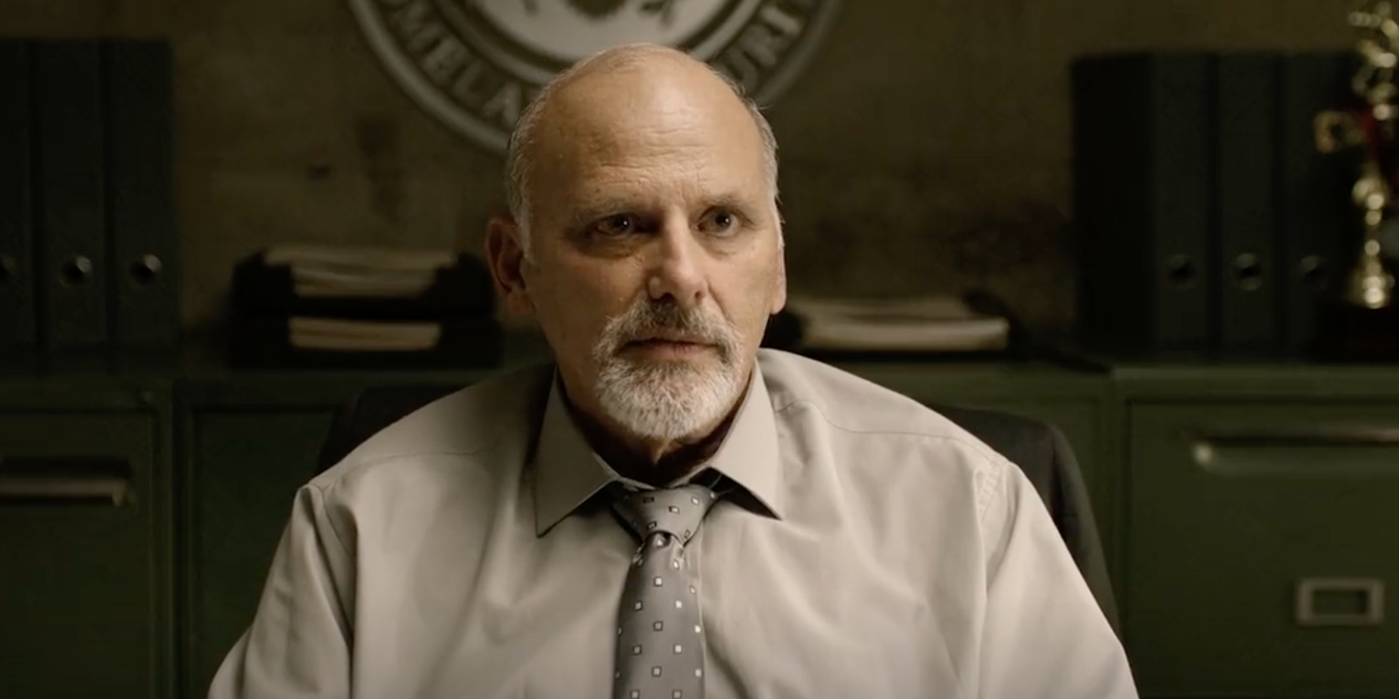 Kurt Fuller as Frost sitting at a desk in Sound of Freedom