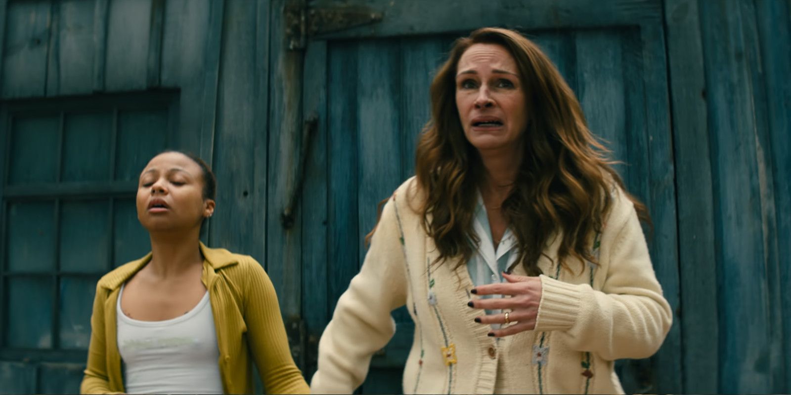 Ruth Scott (Myha'la) and Amanda Sandford (Julia Roberts) looking terrified and staring at something offscreen in Leave the World Behind