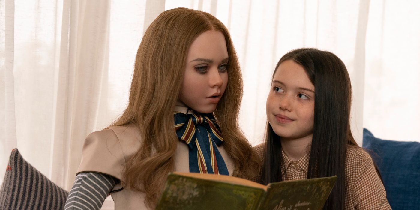 Amie Donald as M3gan and Violet McGraw as Cady from M3gan reading a book