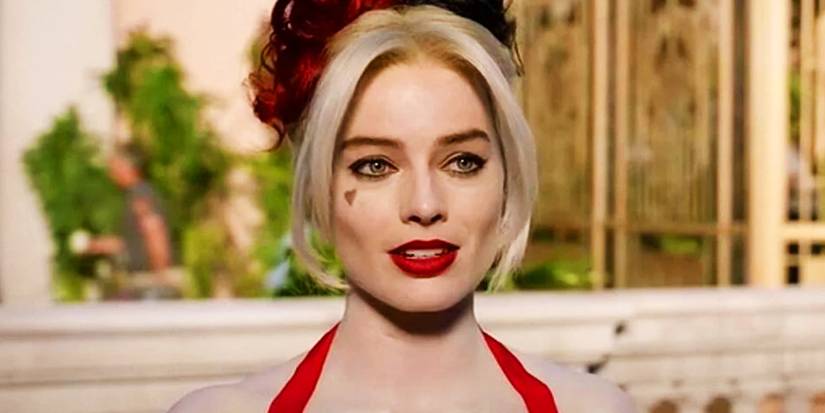 Margot Robbie as Harley Quinn smiling slightly at Luna's palace in The Suicide Squad