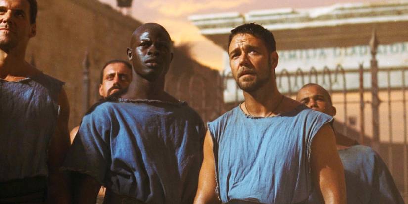 Russell Crowe as Maximus and Djimon Hounsou as Juba standing next to each other in Gladiator