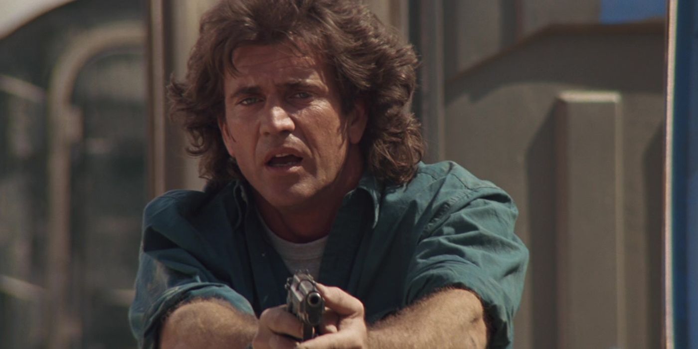 Mel Gibson as Martin Riggs aims his gun at someone off-screen in Lethal Weapon 3.