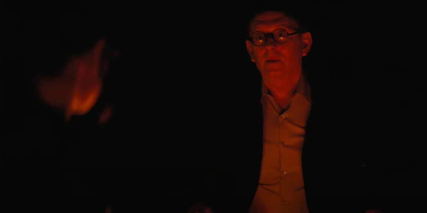 Michael Emerson as Wilzig sat by a fire in Fallout