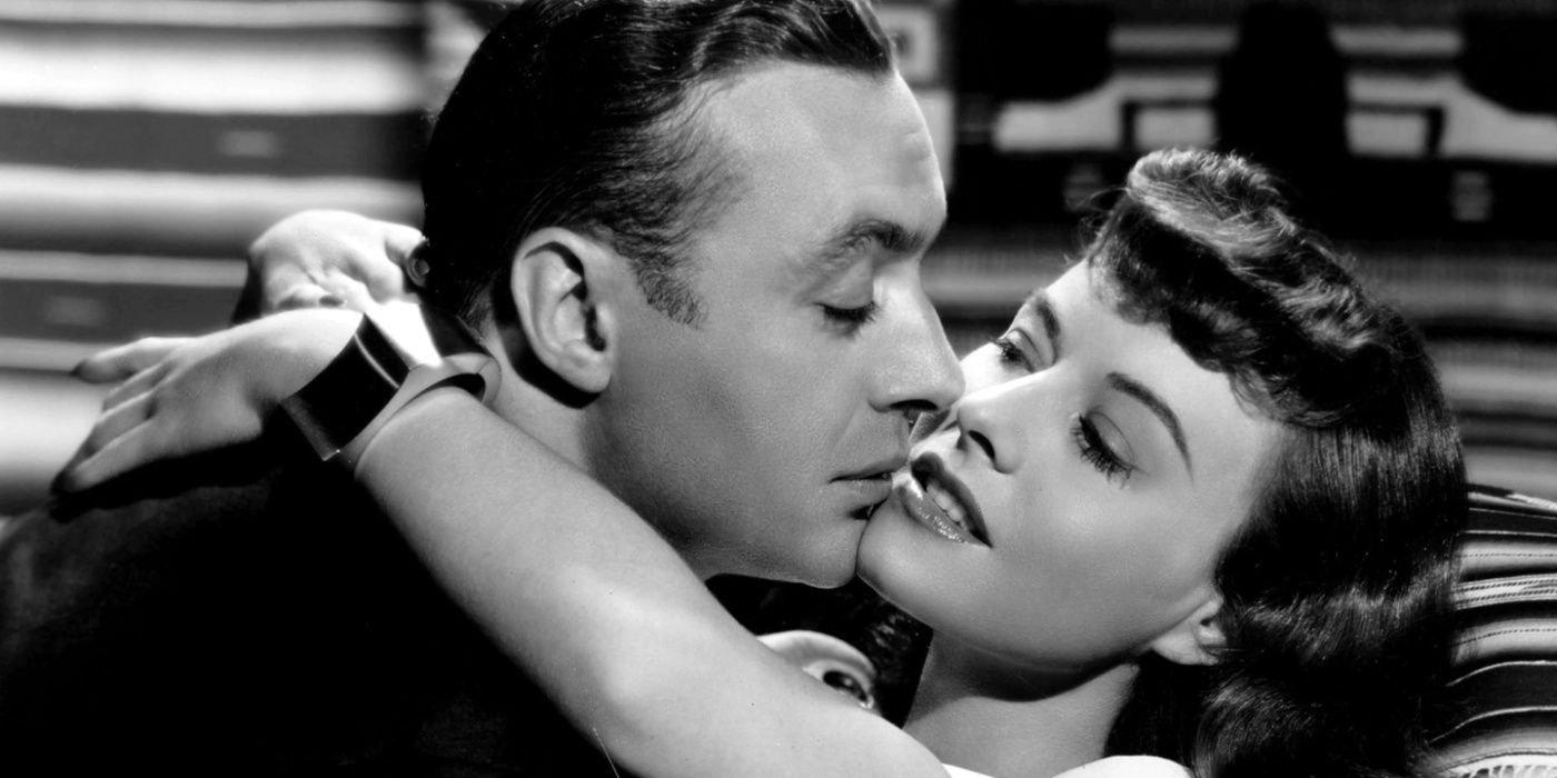 A man and woman kissing in Hold Back the Dawn