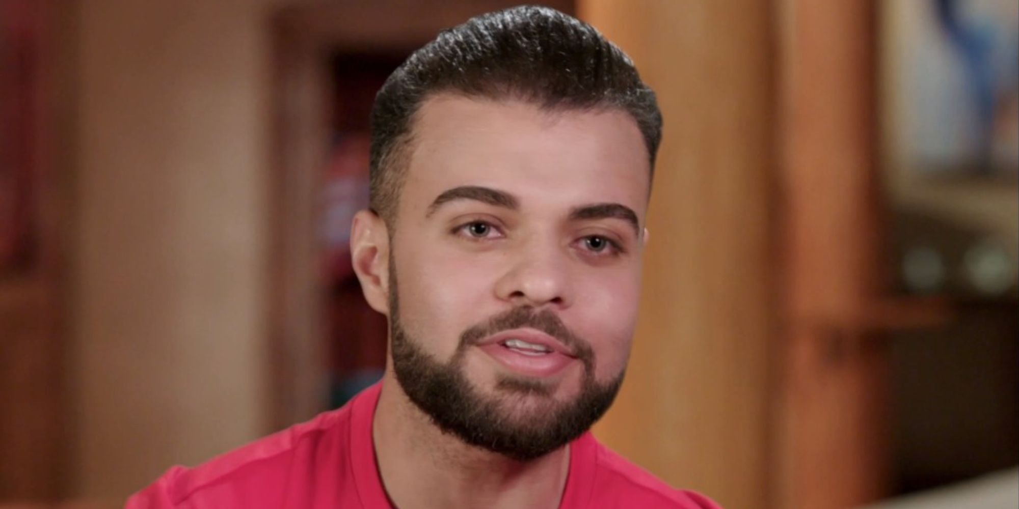 Mohamed Abdelhamed from 90 Day Fiance Season 9 in red shirt for interview