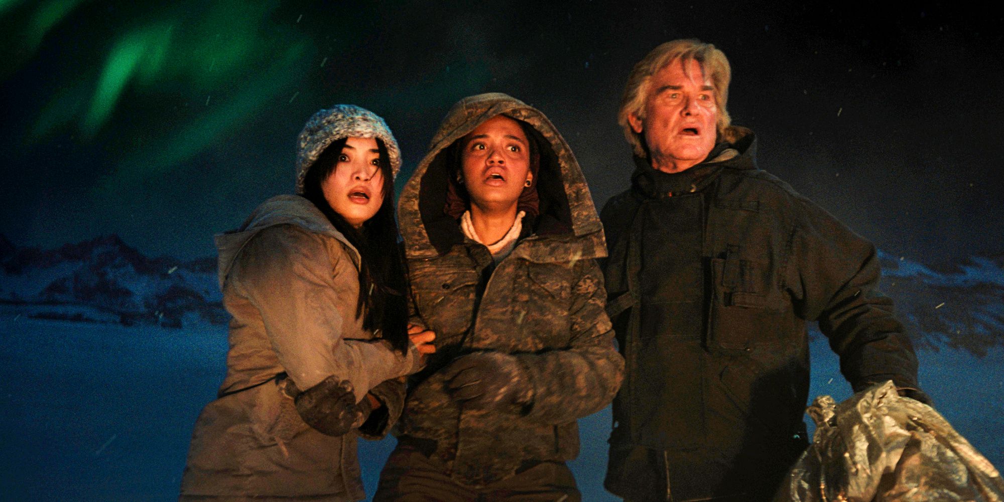 Monarch Legacy of Monsters characters looking scared with northern lights behind them