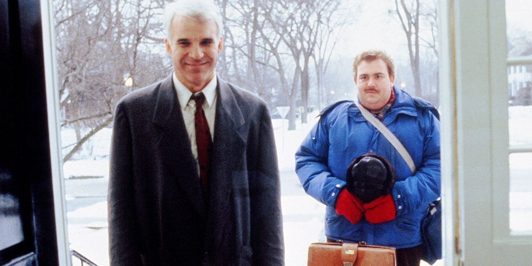 Neal and Del at the front door of the house in Planes Trains and Automobiles