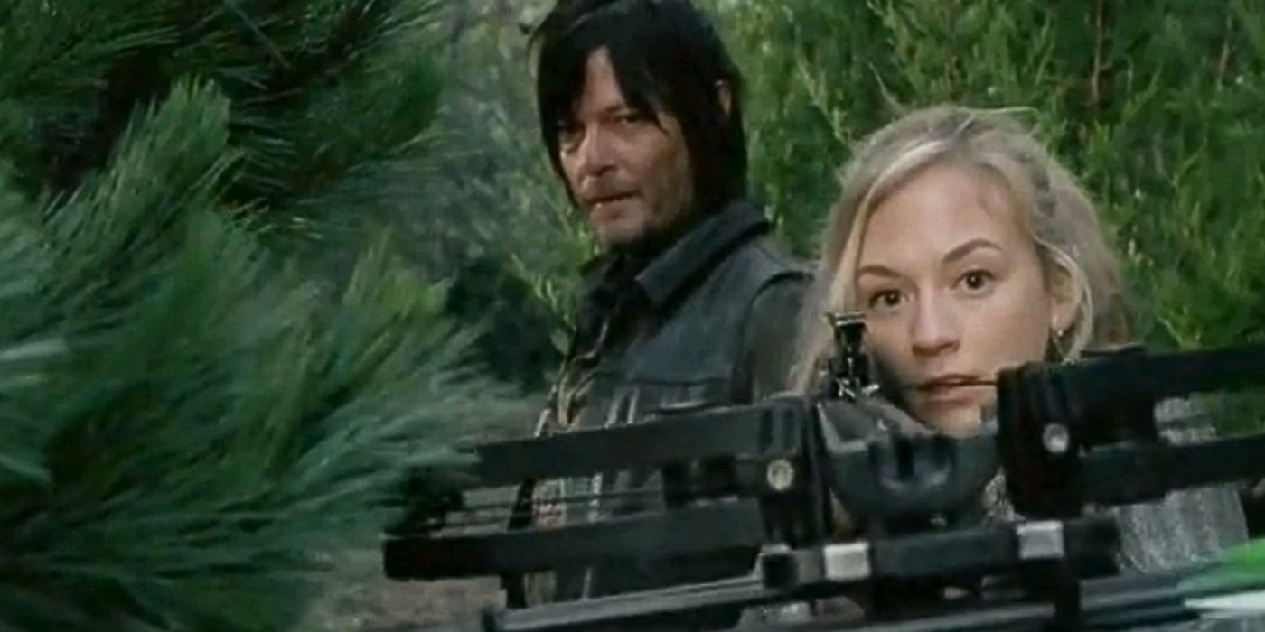 Norman Reedus as Daryl Dixon looks over Beth's shoulder as she aims a crossbow in The Walking Dead