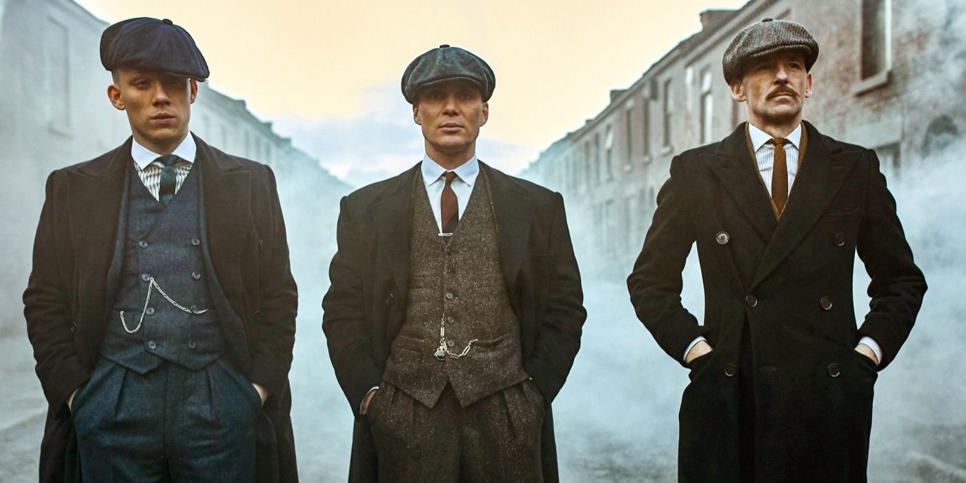 Three men stand on a foggy street in Peaky Blinders 