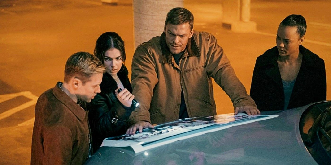 Reacher surrounded by the new season 2 cast looking at some documents on the hood of a car