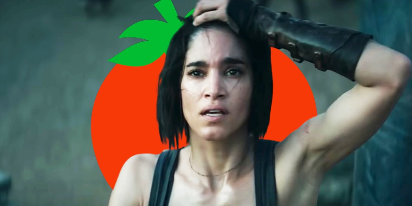 Kora (Sofia Boutella) with her hand on her head in worry in Rebel Moon with a Rotten Tomatoes logo behind her head.