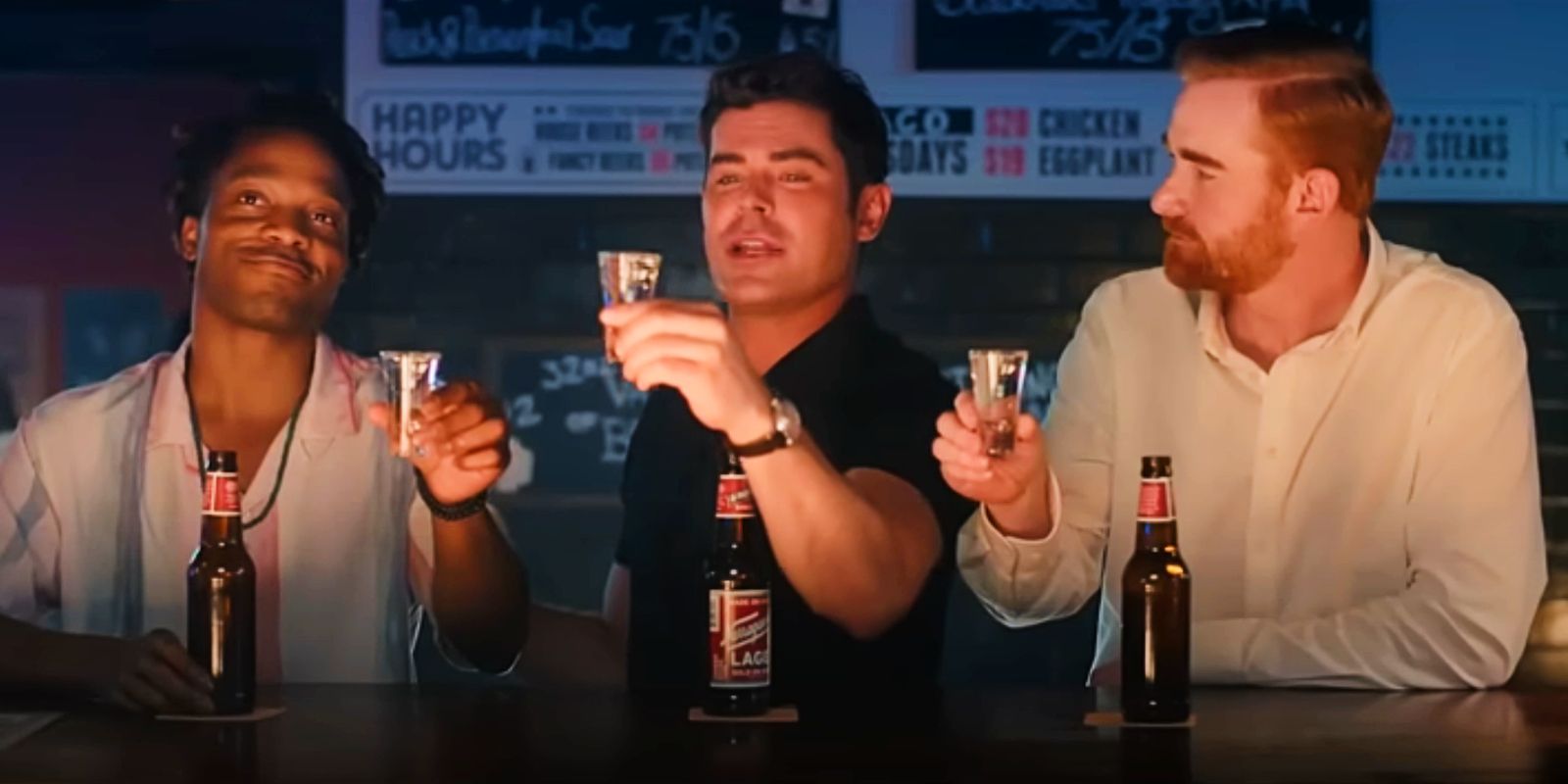 Three friends sit at a bar holding up shot glasses in the trailer for Ricky Stanicky.