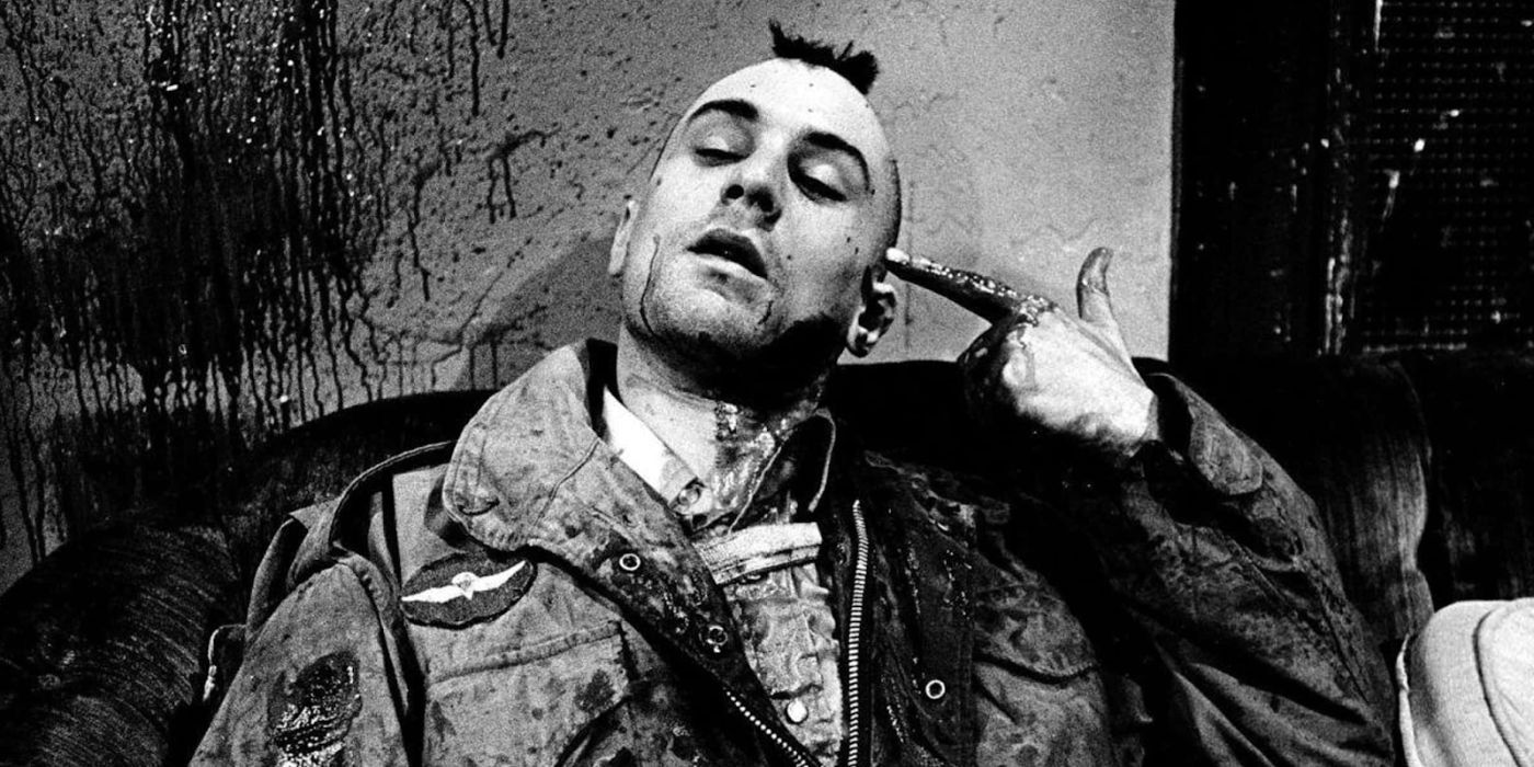 Robert De Niro as Travis Bickle holds his bloody index finger to his head in Taxi Driver.