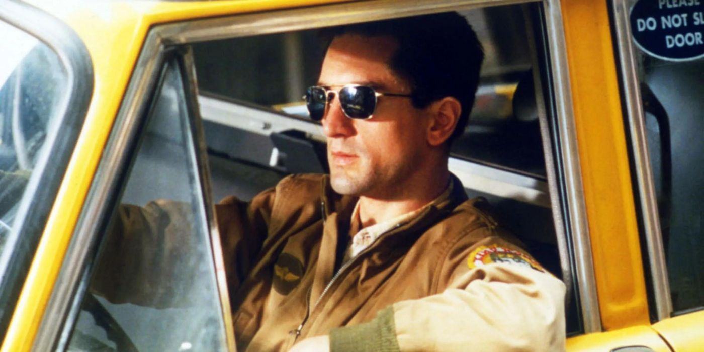 Robert De Niro as Travis Bickle sits in his taxi cab with shades on in Taxi Driver.