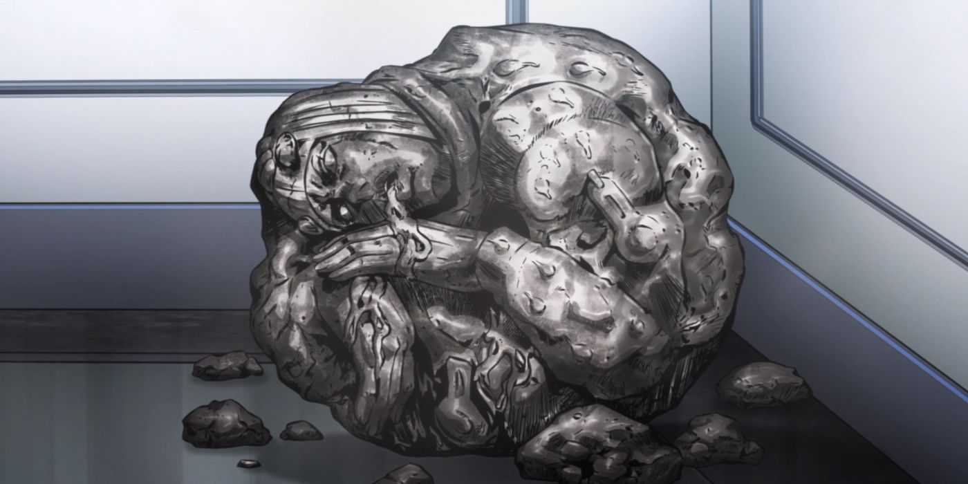 A circular rock in the shape of a man sits in the corner of a room.