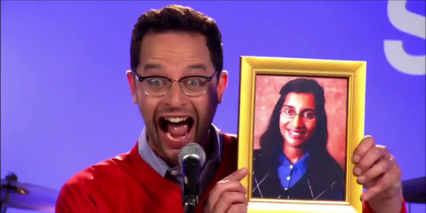 Ruxon (Nick Kroll) shouting into a microphone and holding up the photo of Shiva in The League.