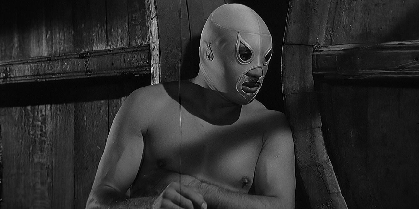 Santo (Rodolfo Guzmán Huerta) sitting in the shadows in Santo vs. The Evil Brain.