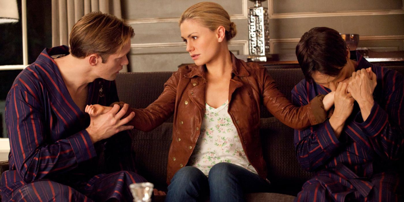 Eric (Alexander Skarsgard) and Bill (Stephen Moyer) holding Sookie's (Anna Paquin) wrists in True Blood