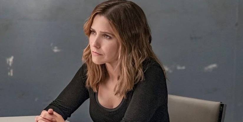 Erin Lindsay sitting at interrogation table with hands interlocked in Chicago PD
