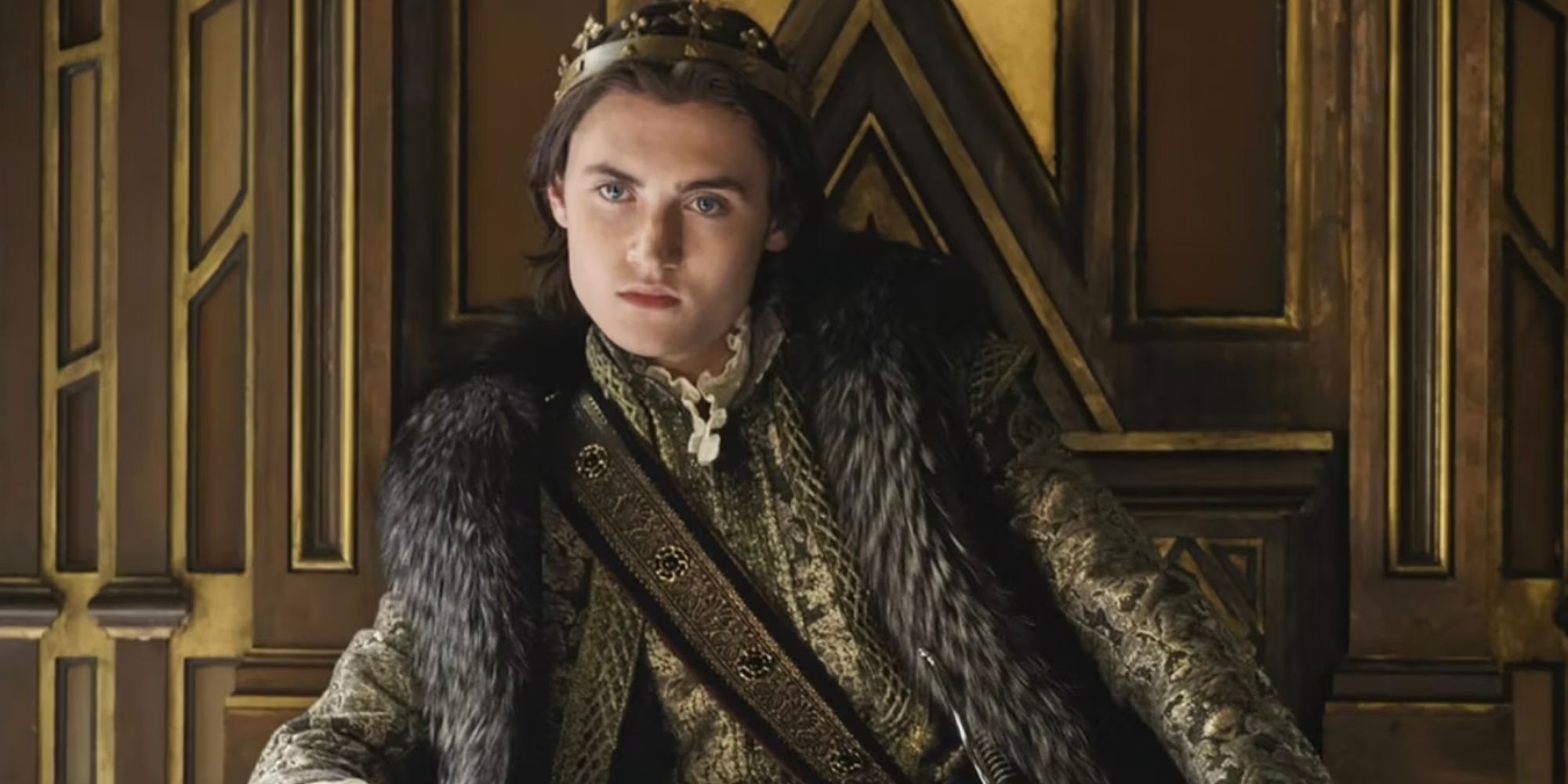 Spencer Macpherson sitting on the throne as Charles in Reign