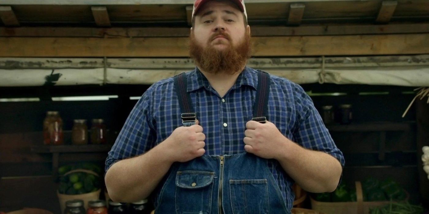 Squirrelly Dan (K. Trevor Wilson) holding the straps of his overalls in Letterkenny