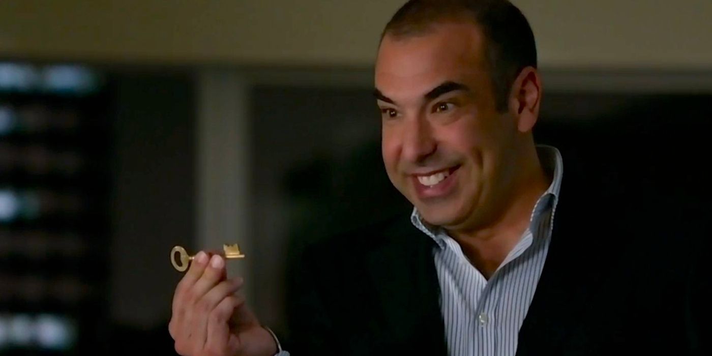 Louis Litt holding a key and smiling in Suits