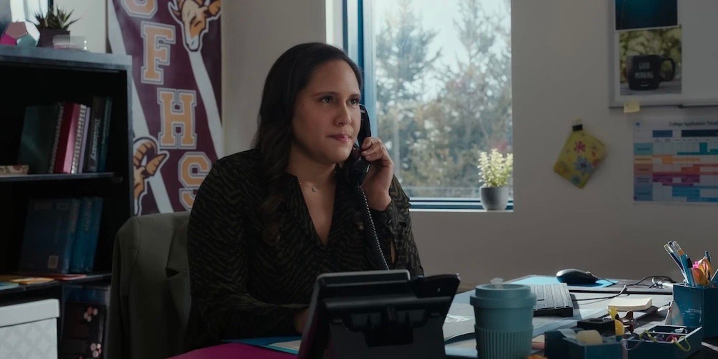 Tara in her office, holding a phone to her face