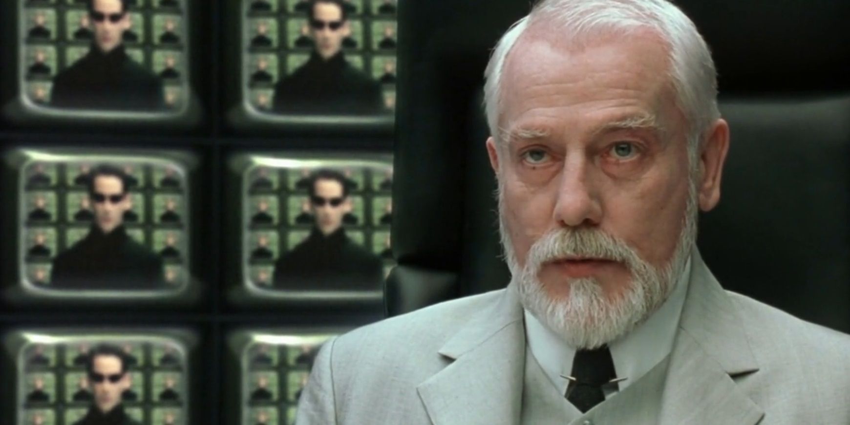 The Architect surrounded by TV screens in The Matrix Reloaded
