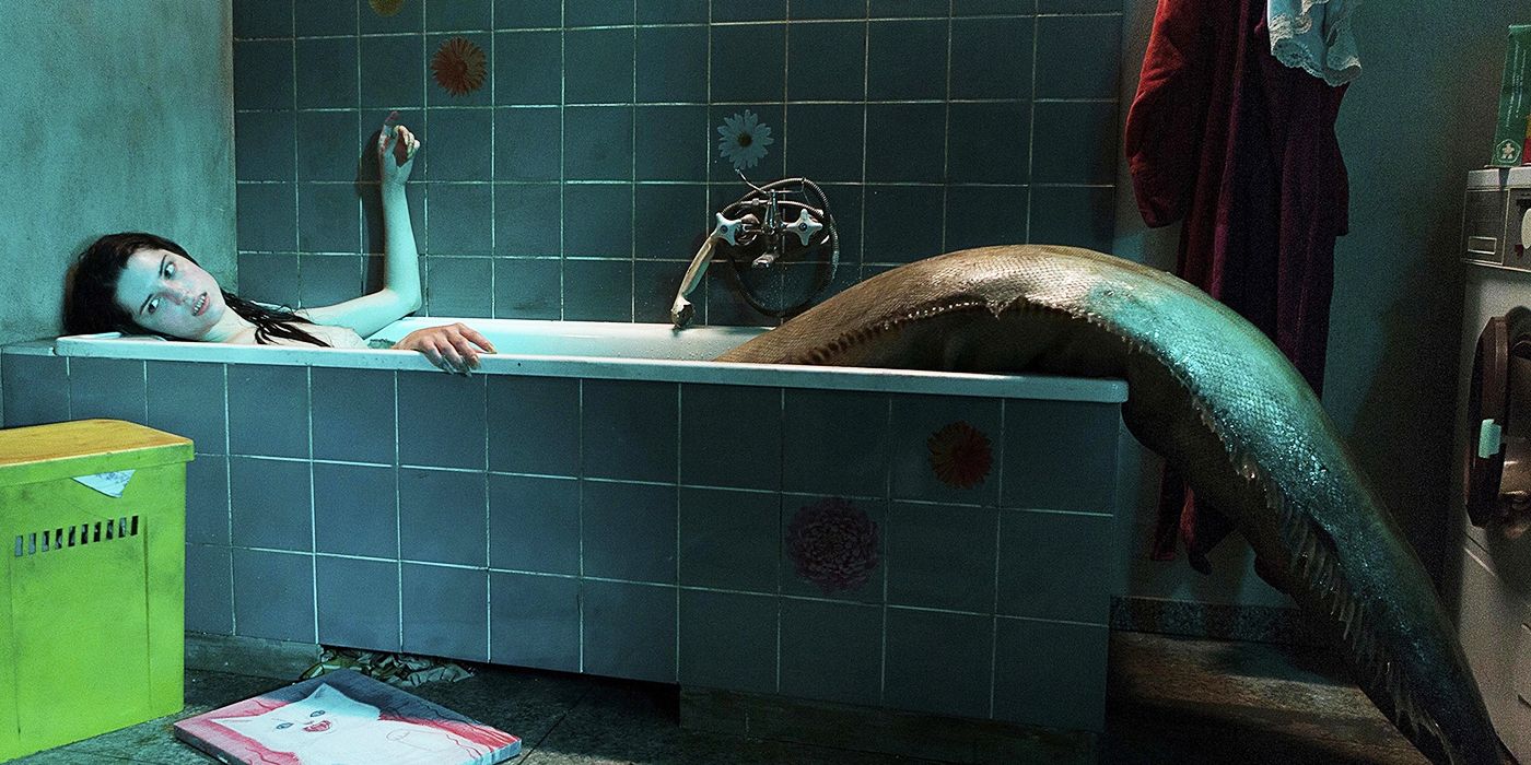 The Lure Golden in her siren form inside a bathtub