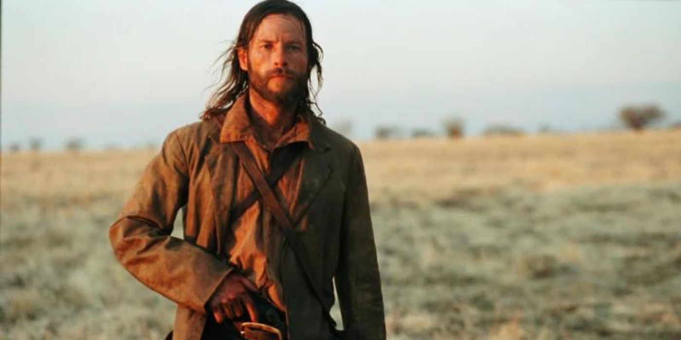 Charlie (Guy Pearce) prepares to brandish his revolver while in a deserted wasteland in The Proposition