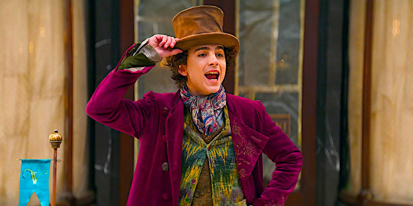 Timothee Chalamet giving a speech while holding his hat as Willy Wonka in a scene from Wonka