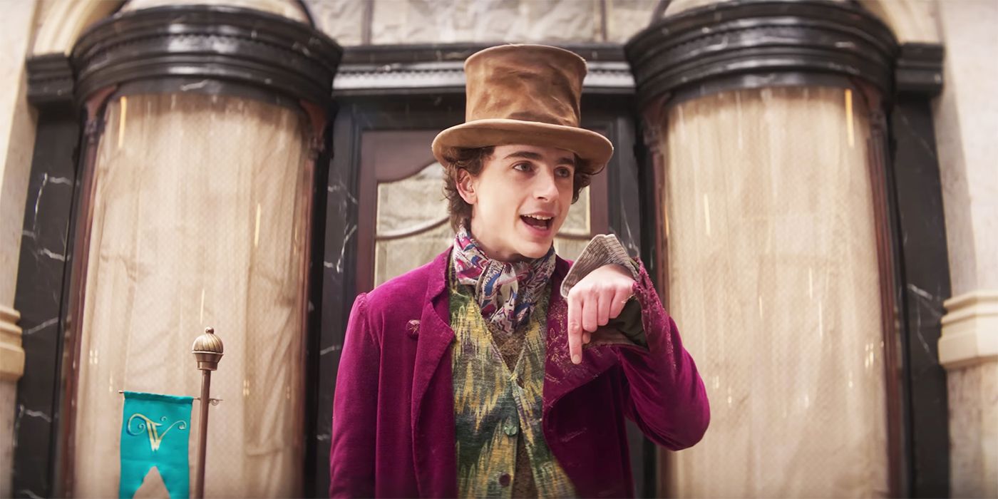 Timothee Chalamet as Willy Wonka talking and pointing down