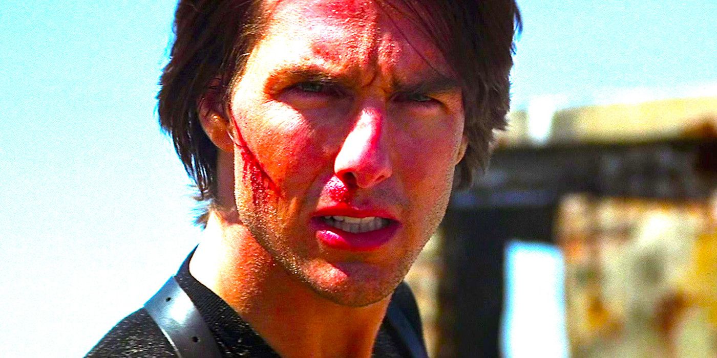 Tom Cruise with a slashed cheek squinting dramatically in Mission Impossible 2