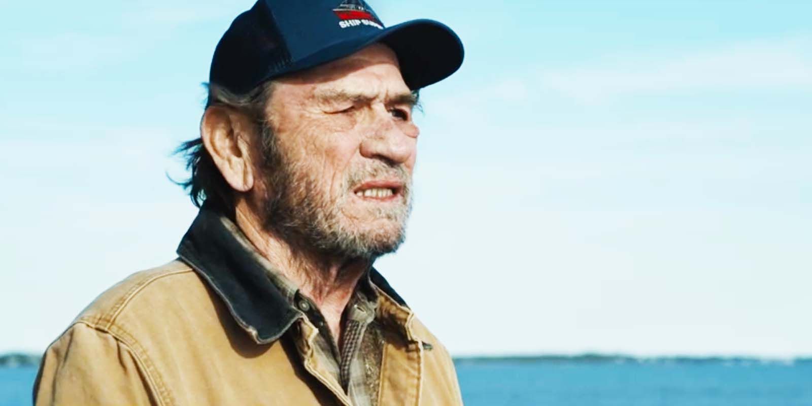 Tommy Lee Jones as Ray Eldridge in a baseball cap staring out somewhere in 2023's Finestkind