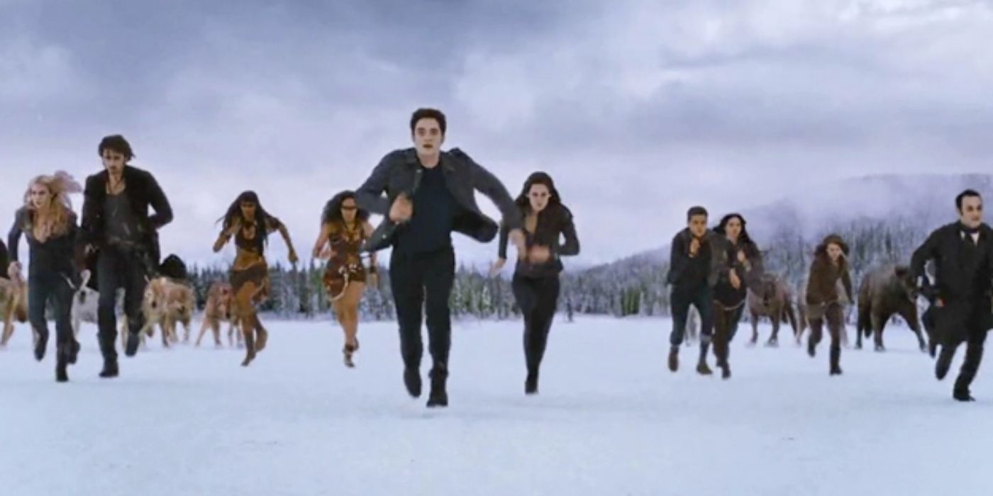 Bella, Edward and other running towards something in a snowy field in Breaking Dawn Part 2