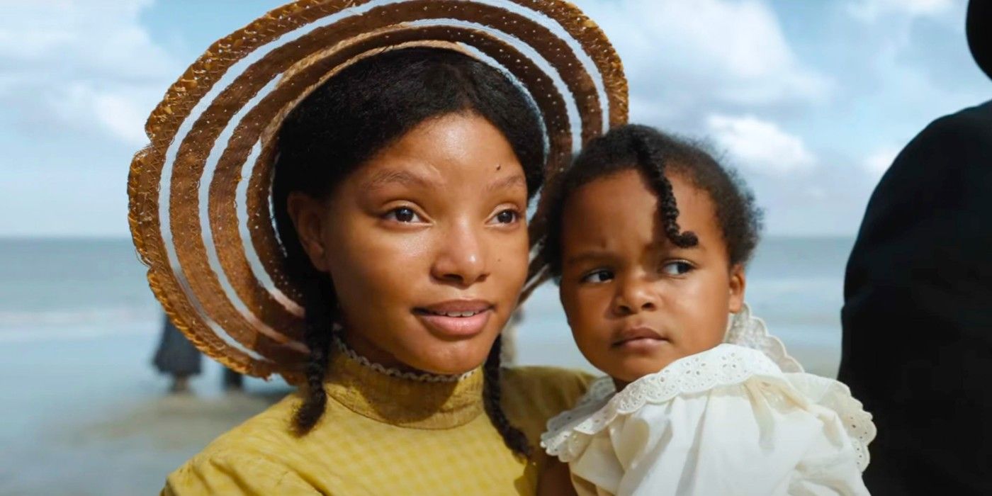 Halle Bailey as Nettie Harris holding a baby in The Color Purple (2023)