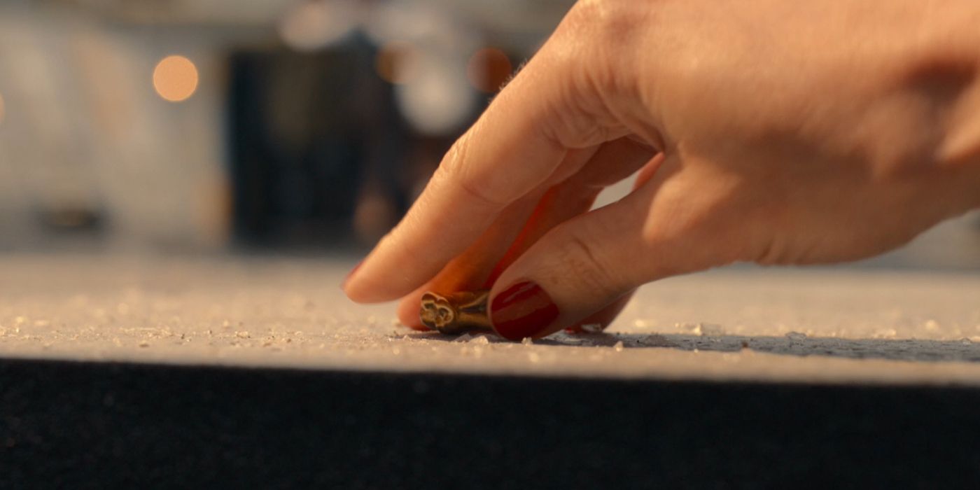 A hand picks up the Master's tooth in Doctor Who episode The Giggle