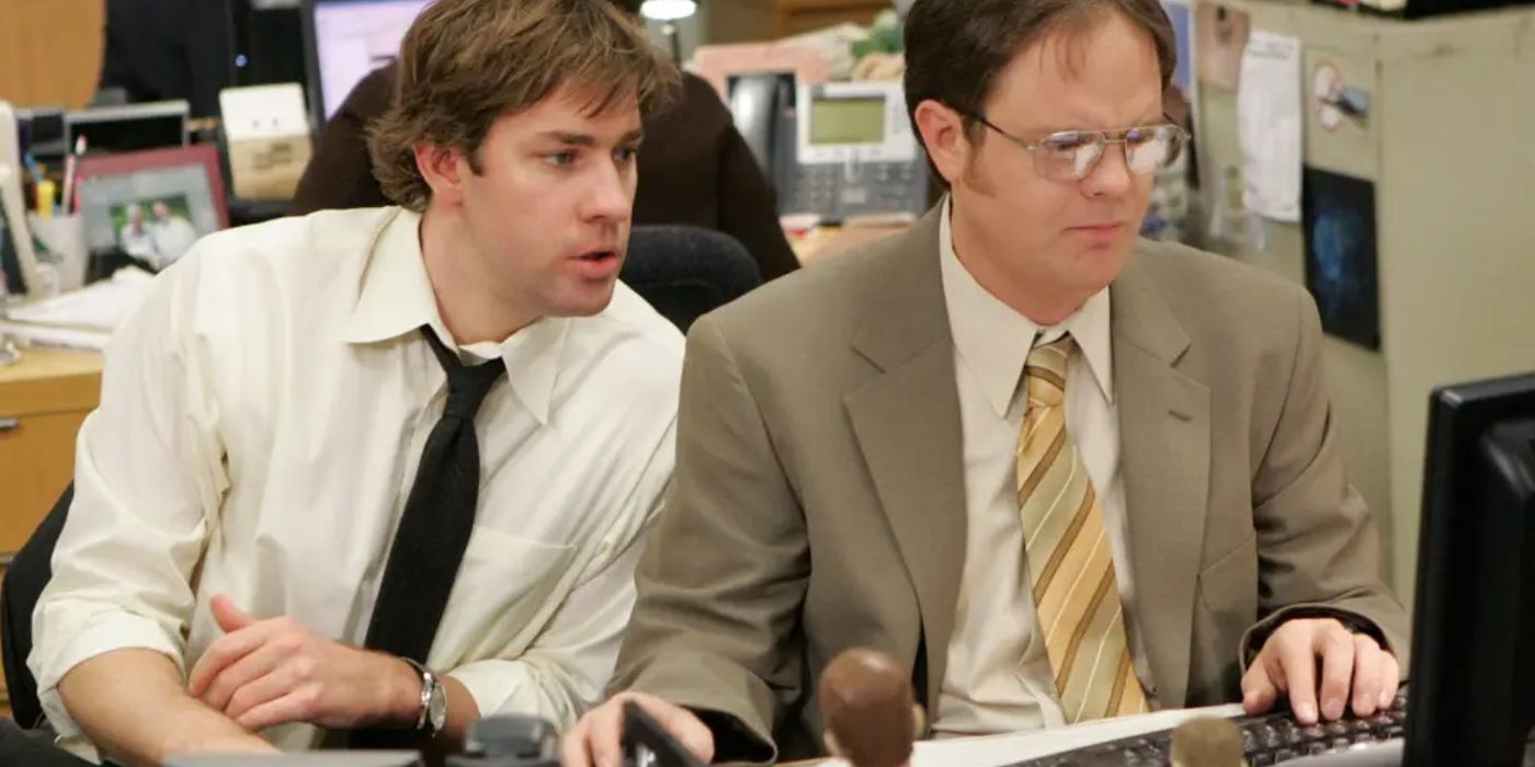 John Krasinski as Jim peering over Dwight's shoulder in The Office