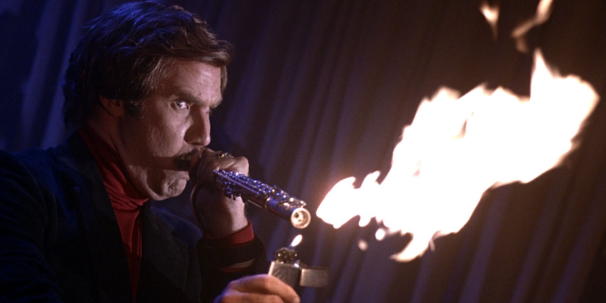 Will Ferrell as Ron Burgundy in Anchorman blowing fire from his flute