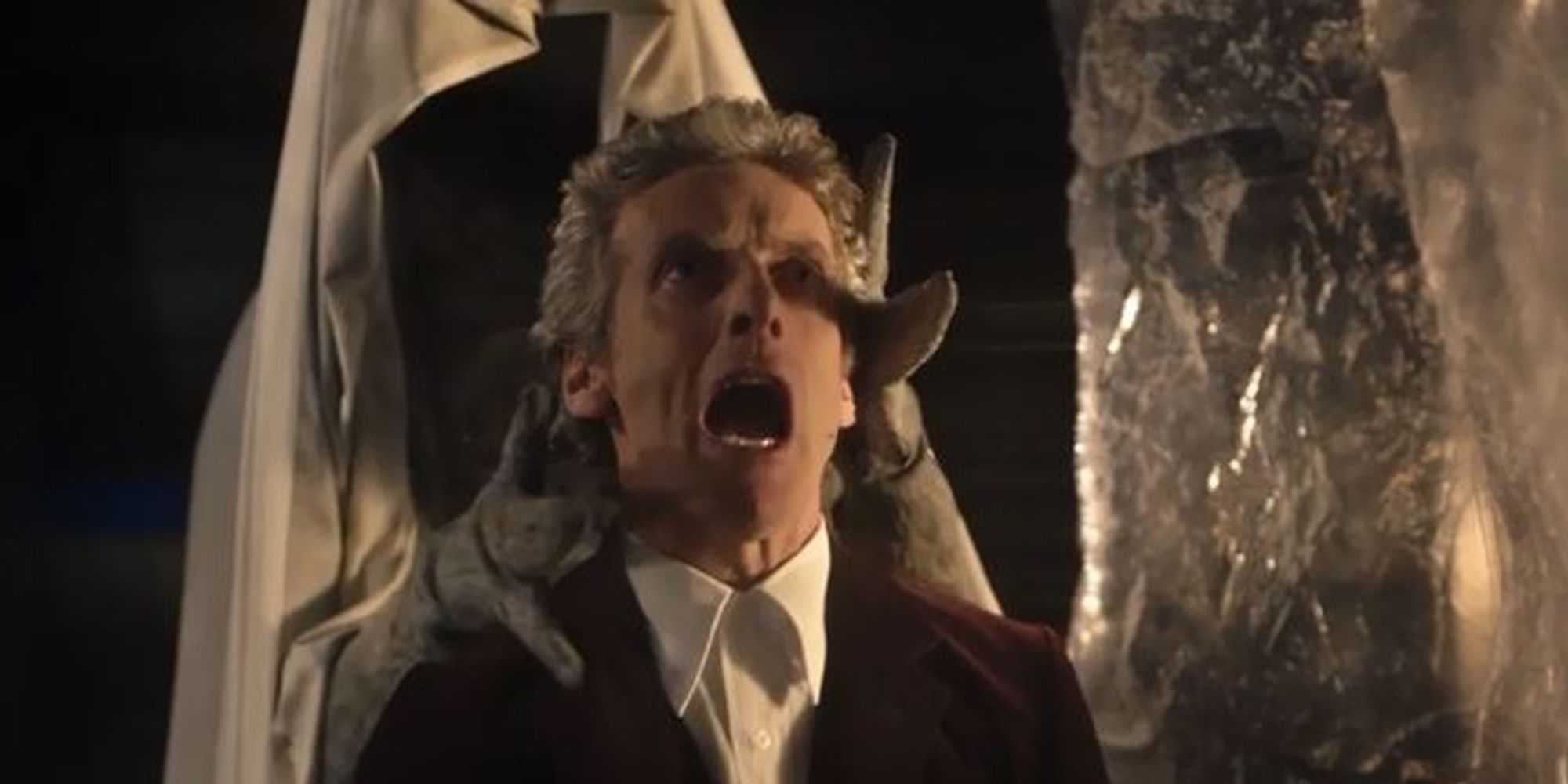 Peter Capaldi looks distressed as the Twelfth Doctor as he is caught from behind in Doctor Who's "Heaven Sent""