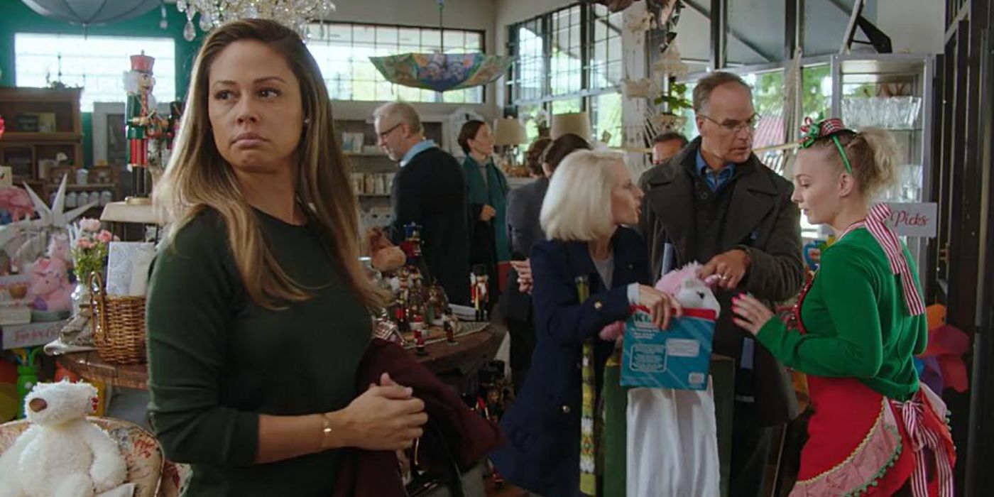Vanessa Lachey as Abby Hewitt looking annoyed in a department store in A Twist of Christmas.